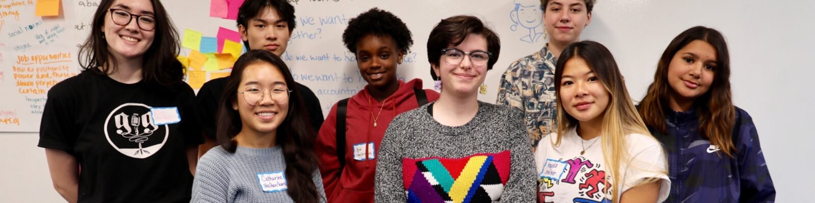 Image of students standing in front of white board