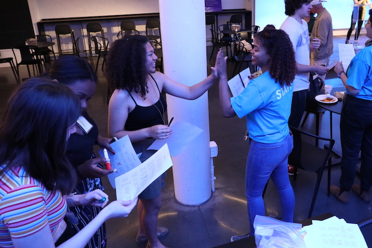 Students high-fiving each other